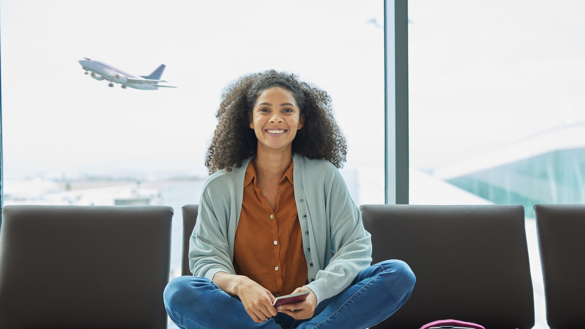 Airport, black woman and portrait of a young person at flight terminal waiting for airplane travel.
