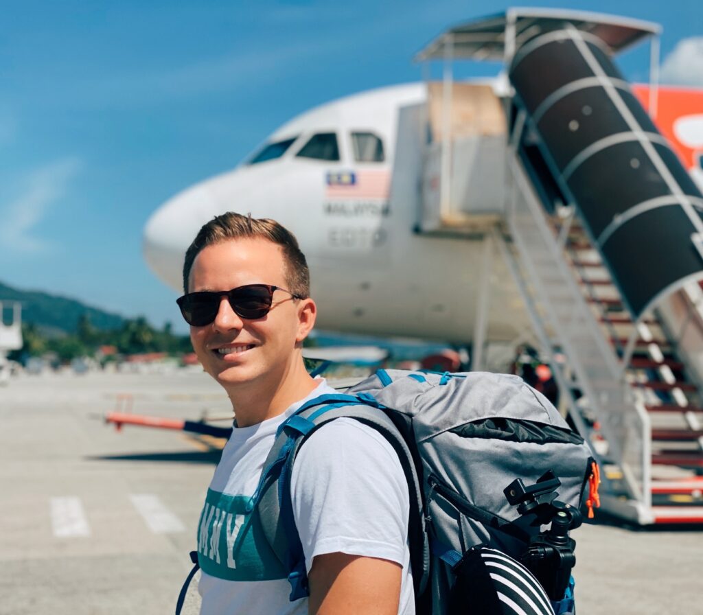 Male backpacker ready to board airplane