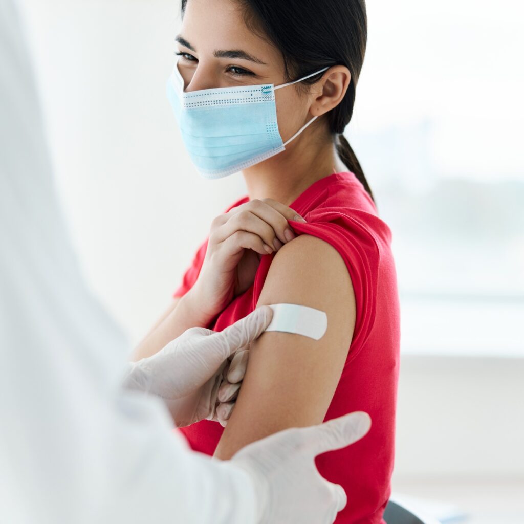 woman wearing medical mask patient injection coronavirus